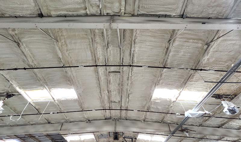 Leed Insulation open-cell spray foam applied to a commercial metal building roof deck at Bev Smith Toyota in Fort Pierce, FL.