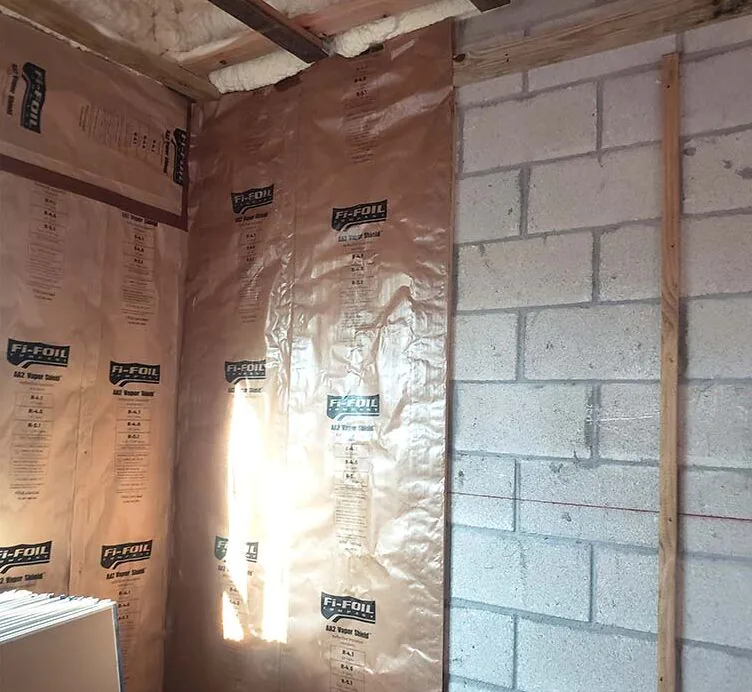 Leed Insulation Fi-Foil radiant barrier installed on interior walls next to a concrete block exterior wall in Fort Pierce, FL.